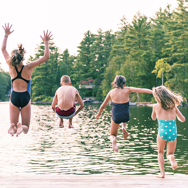 kids jumping into lake