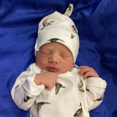 newborn baby in white onesie