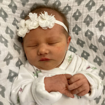 newborn baby in white onesie
