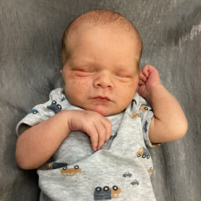newborn baby in truck onesie