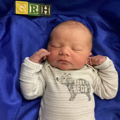 newborn baby in baby bear onesie