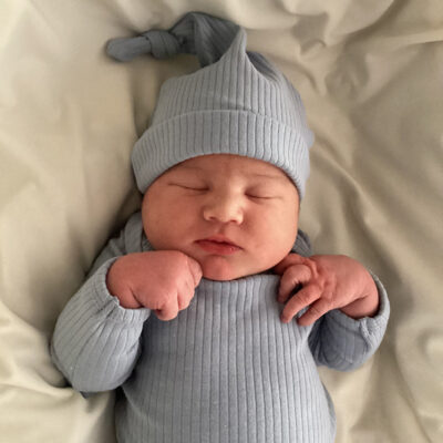 newborn baby in light grey onesie