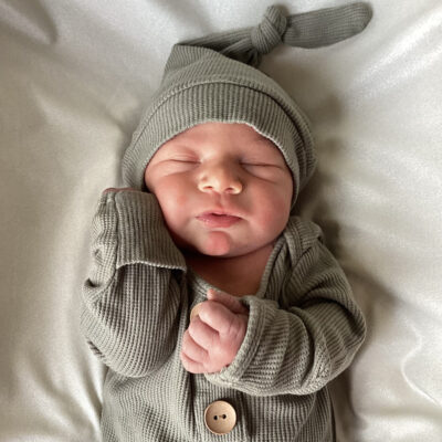 newborn baby in light green onesie