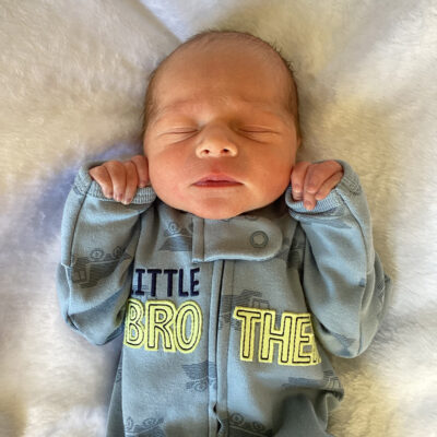 newborn baby in grey onesie