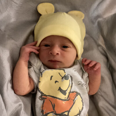 newborn baby with Pooh onesie