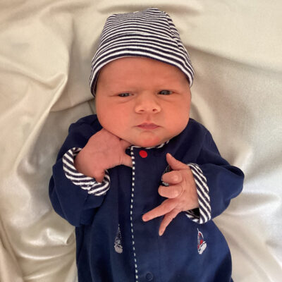newborn baby with blue striped onesie
