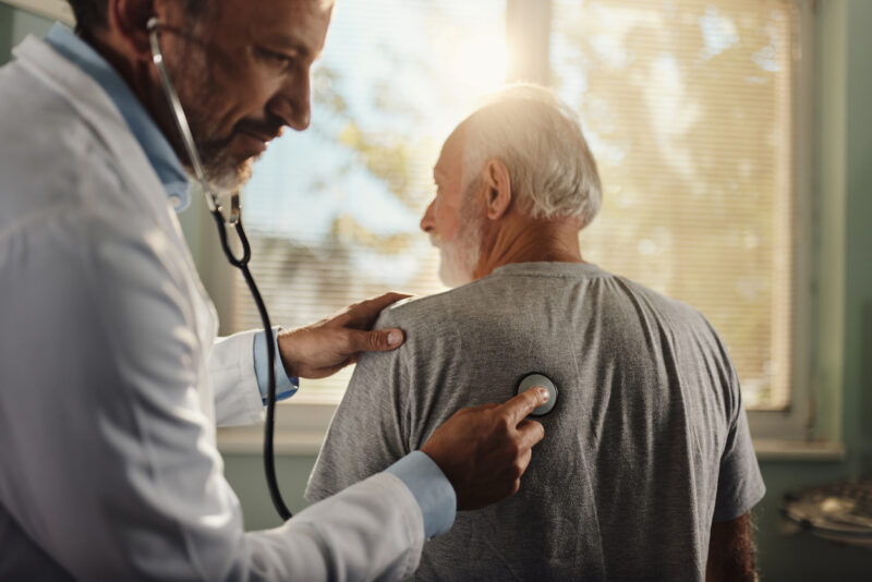 doctor listening to patients lungs
