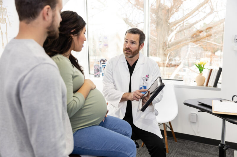 Doctor explains test results to expectant couple