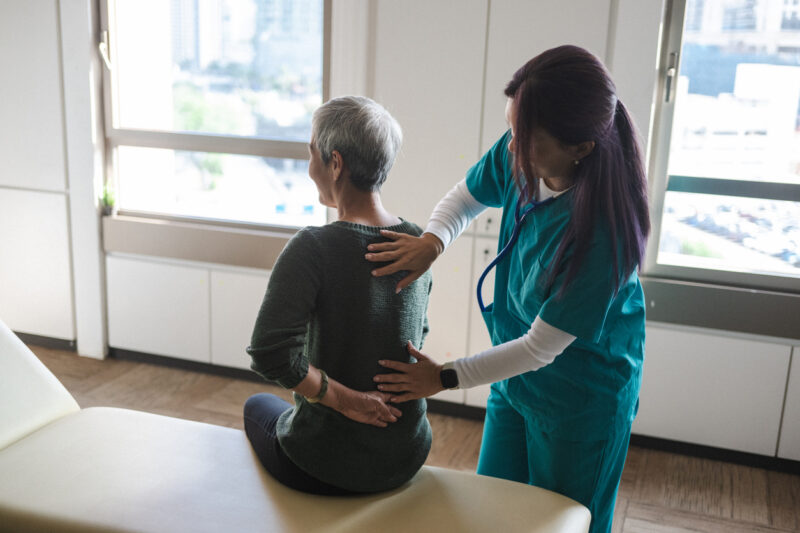 Physiotherapist Aids Senior in Recovery