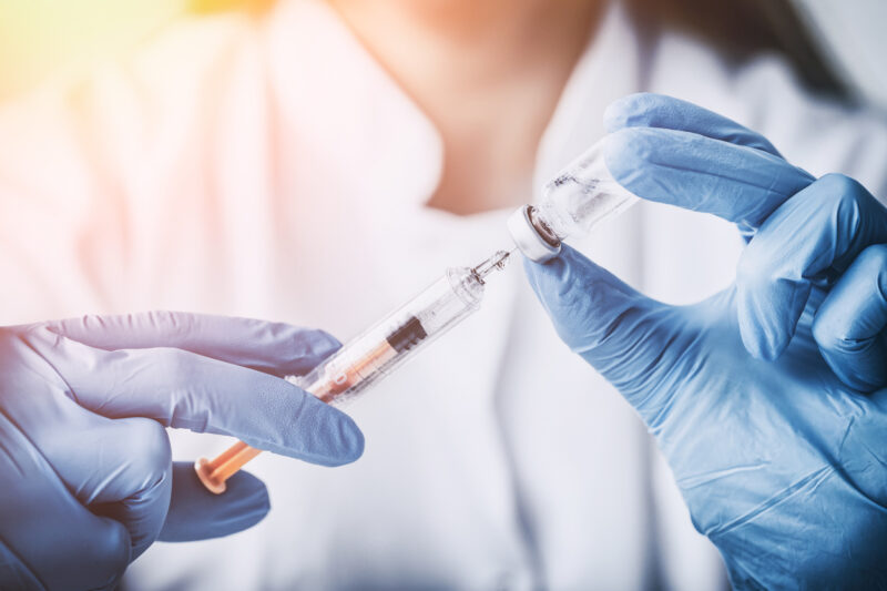 doctor injecting vaccine