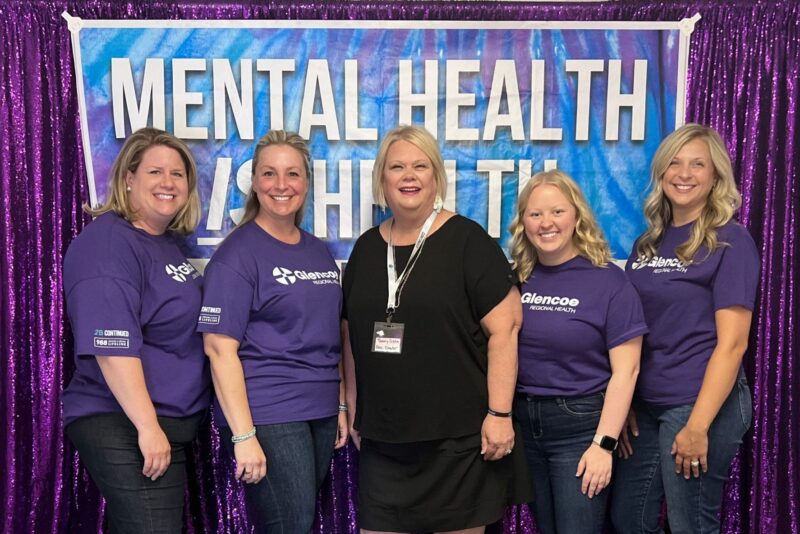 GRH team in front of mental health is health banner