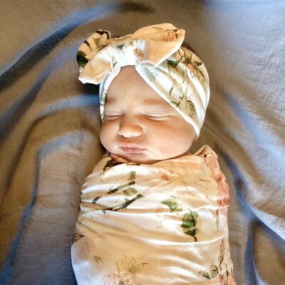 baby wrapped in floral swaddling clothes