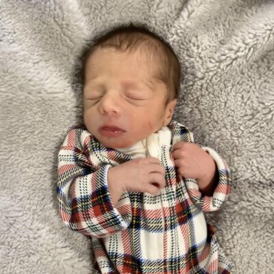 baby wearing checked onesie