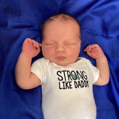 baby wearing strong like daddy onesie
